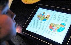 Photo of Child Reading eBook On Tablet